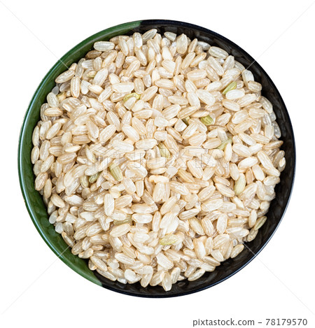 unpolished brown rice in round bowl isolated 78179570