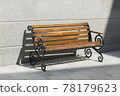 Empty wooden bench among concrete in the sunny day. Light and shadow 78179623