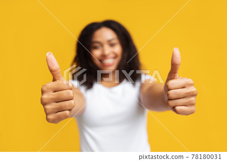 I like It. Happy african american lady gesturing thumbs up with both hands over yellow background, selective focus I like It. Happy african american lady gesturing thumbs up with both hands over yellow background, selective focus 78180031