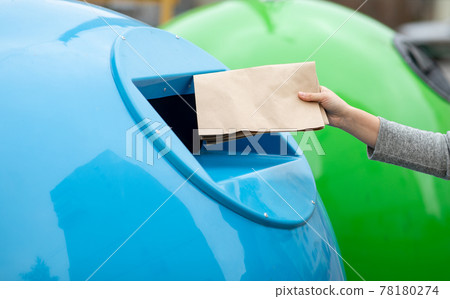 Waste Sorting. Unrecognizable Female Throwing Paper Bag Into Blue Garbage Recycle Bin Waste Sorting. Unrecognizable Female Throwing Paper Bag Into Blue Garbage Recycle Bin 78180274