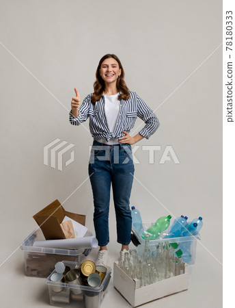 Sustainability Concept. Woman Standing Next To Containers With Different Materials For Recycling Sustainability Concept. Woman Standing Next To Containers With Different Materials For Recycling 78180333