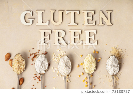 Metal spoons of various gluten free flour almond flour, oatmeal flour, buckwheat flour, rice flour, corn flour and gluten free lettering made of wooden letters, flat lay, top view Metal spoons of various gluten free flour almond flour, oatmeal flour, buckwheat flour, rice flour, corn flour and gluten free lettering made of wooden letters, flat lay, top view 78180727