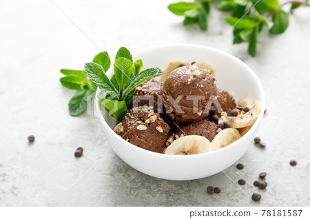Chocolate and banana fruit ice cream with almond nuts served in bowls 78181587