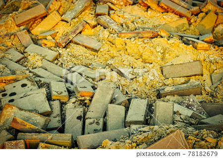 Damaged pavement of gray bricks and yellow sand base, repair street area road works 78182679
