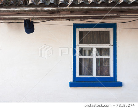 old window outside a rustic white house old window outside a rustic white house 78183274