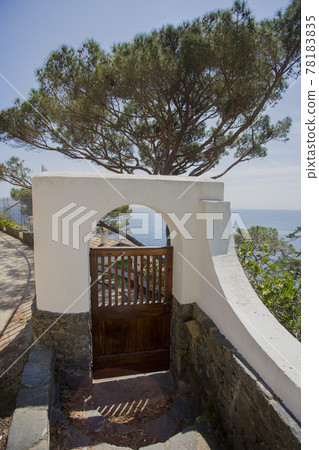 Door to heaven concept. Picturesque wooden wicket to house on Mediterranean Sea Door to heaven concept. Picturesque wooden wicket to house on Mediterranean Sea 78183835