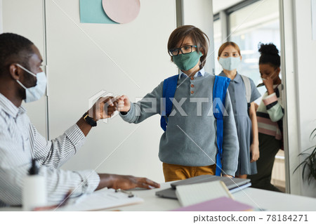 Teacher Greeting Kids in Classroom 78184271