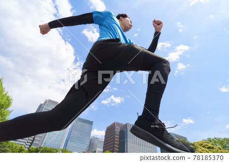 A young man jogging under the blue sky 78185370