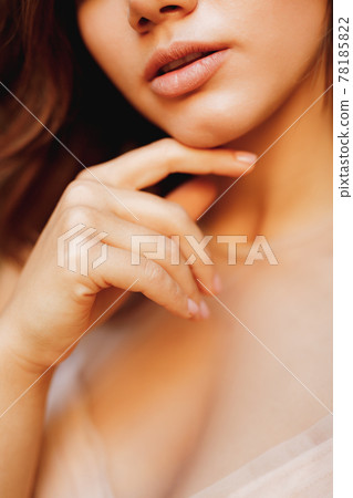Half-portrait of a lovely girl in a pastel wedding dress and nude manicure 78185822