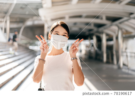 Happy smile young adult business asian woman wear face mask for protect virus corona or covid19 Happy smile young adult business asian woman wear face mask for protect virus corona or covid19 78190617