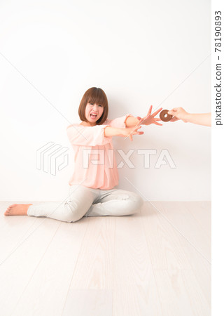 A young woman who is confused by being robbed of a snack 78190893