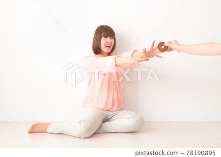 A young woman who is confused by being robbed of a snack 78190895