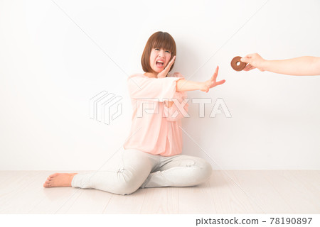 A young woman who is confused by being robbed of a snack 78190897