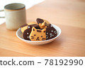 Cat-shaped cookie decorated with chocolate pen 78192990