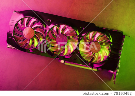 Powerful graphics card with three fans and a futuristic red-green neon backlight. 78193492