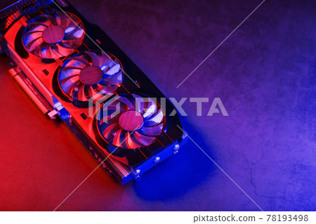 Large and powerful graphics card with three fans with blue pink light. Large and powerful graphics card with three fans with blue pink light. 78193498