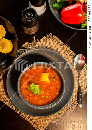 Mexican tomato, bean, bell pepper soup and corn in the dark bowl. Mexican tomato, bean, bell pepper soup and corn in the dark bowl. 78194122