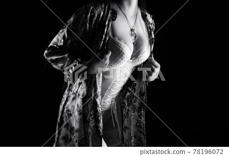 Black and white photo of the adult posing woman in silk negligee Black and white photo of the adult posing woman in silk negligee 78196072