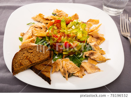 Trout fillets with guacamole salad Trout fillets with guacamole salad 78196532