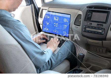 Mechanic using laptop computer to check during work a car engine on car at repair garage. focus finger hand. Mechanic using laptop computer to check during work a car engine on car at repair garage. focus finger hand. 78196940