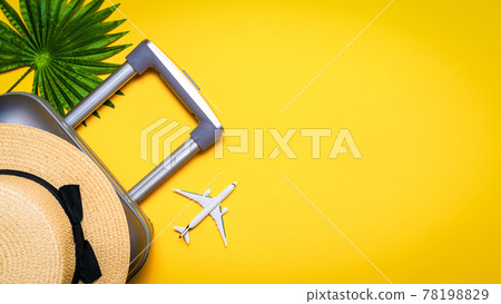 Sea background. Travel accessories with suitcase, white plane, palm leaves in minimal trip vacation concept on yellow background. Summer vacation and product advertisement concept. 78198829
