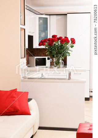 Woman takes dead dry bouquet of roses flowers out of vase. Housewife taking care of coziness on kitchen. Woman takes dead dry bouquet of roses flowers out of vase. Housewife taking care of coziness on kitchen. 78200613