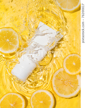 Cosmetic tube in water,lemon slices,yellow bg Cosmetic tube in water,lemon slices,yellow bg 78200817
