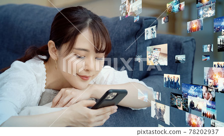 Women watching videos on their smartphones Digital content 78202937