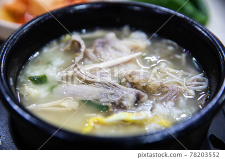 Chicken gomtang with eggs, green onions, mushrooms and vermicelli by boiling chicken in a pot, traditional Korean food Chicken gomtang with eggs, green onions, mushrooms and vermicelli by boiling chicken in a pot, traditional Korean food 78203552