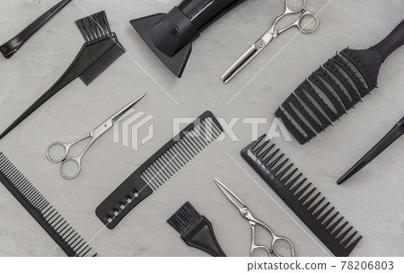 Full frame with hairdressing tools, combs, scissors on a gray background. Hair salon accessories, top view Full frame with hairdressing tools, combs, scissors on a gray background. Hair salon accessories, top view 78206803