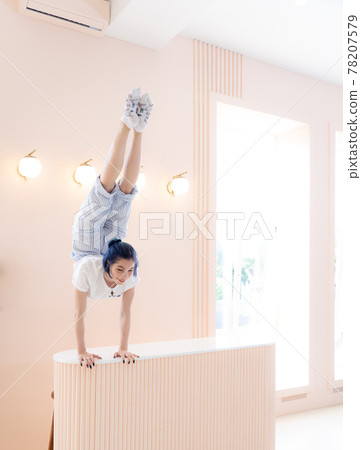 Flexible girl practice stretching and handstand at home. Concept of individuality, creativity and self-confidence 78207579