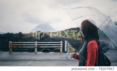 A woman taking a walk in the rainy Hachijojima A woman taking a walk in the rainy Hachijojima 78207667