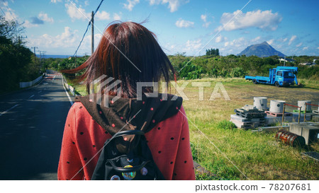 Back view of a woman taking a walk on sunny Hachijojima Back view of a woman taking a walk on sunny Hachijojima 78207681