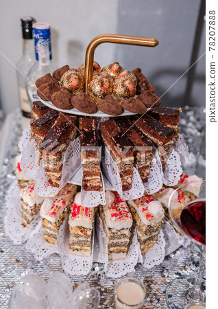 Sweet cakes at a wedding banquet. Catering, sweet festive buffet. Candy bar 78207888
