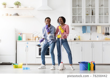 Joyful african american family having fun while cleaning kitchen together 78208442