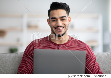Closeup of middle-eastern man using laptop at home Closeup of middle-eastern man using laptop at home 78208448