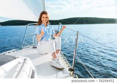 Happy Lady On Yacht Gesturing Thumbs Up Sitting On Deck Happy Lady On Yacht Gesturing Thumbs Up Sitting On Deck 78208452