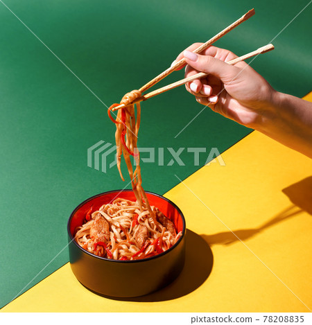 Stir fry soba noodles with beef and vegetables in wok on dark background, Asian udon noodles with beef WOK in black bowl on Slate background. Copy space Stir fry soba noodles with beef and vegetables in wok on dark background, Asian udon noodles with beef WOK in black bowl on Slate background. Copy space 78208835