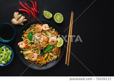 Asian noodles on plate on dark background Asian noodles on plate on dark background 78209115