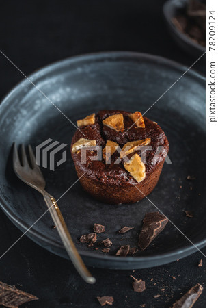 Chocolate muffin with fork served on table 78209124