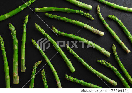 Green asparagus on dark background Green asparagus on dark background 78209364