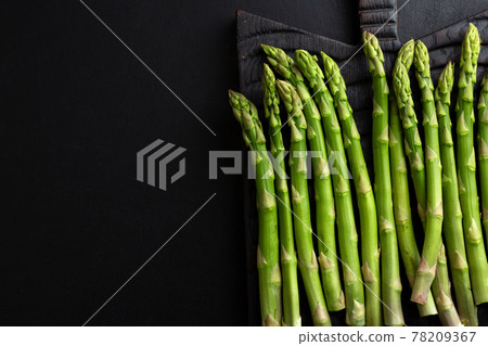 Green asparagus on dark background 78209367