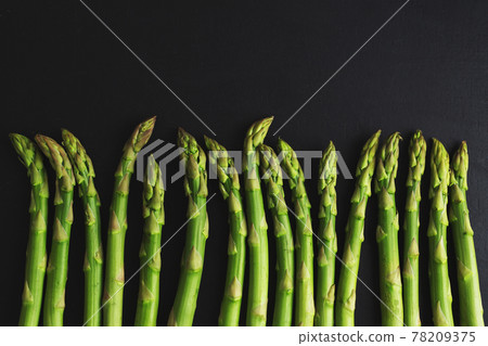 Green asparagus on dark background Green asparagus on dark background 78209375