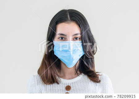young  beautiful asian woman showing how to wear a medical mask or  showing how to correctly wear hygiene surgical mask step by step on white background 78209915