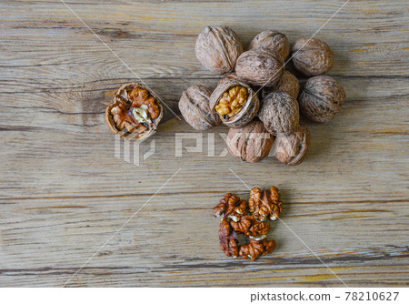 Walnuts closeup on a wooden background, selective focus 78210627
