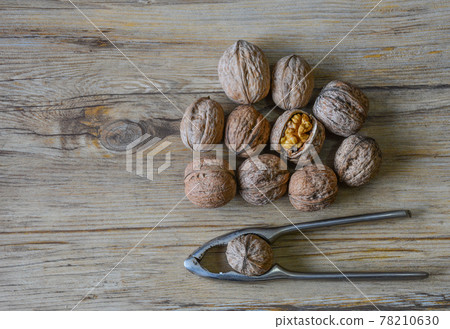Walnuts closeup on a wooden background, selective focus Walnuts closeup on a wooden background, selective focus 78210630