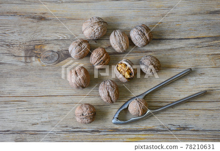 Walnuts closeup on a wooden background, selective focus 78210631