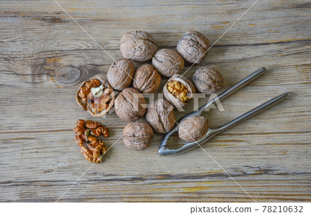 Walnuts closeup on a wooden background, selective focus Walnuts closeup on a wooden background, selective focus 78210632