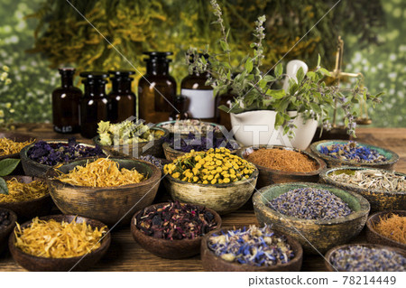 Natural medicine and mortar, healing herbs background Natural medicine and mortar, healing herbs background 78214449