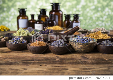 Natural medicine and mortar, healing herbs background Natural medicine and mortar, healing herbs background 78215005